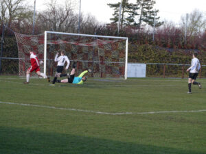 A despairing Lewis Paglia cannot stop Wem taking the lead