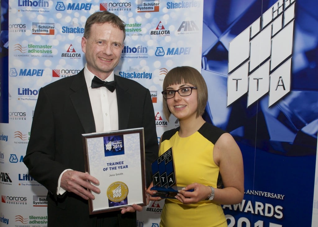 Jess receives her award from Gerald Kelly from the Construction Skills Training Board (CITB) at the Tile Association Awards