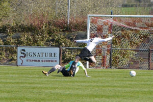 Luke Askey is brought down in front of goal