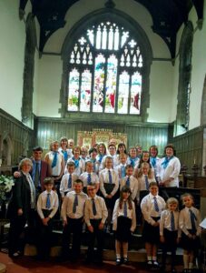 Mrs Campbell-Kelly, husband Ian and some of the the parent-school choir at St Michael's Church last Sunday