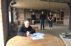 Crown Wharf Theatre trustee Rob Kenney signs the lease