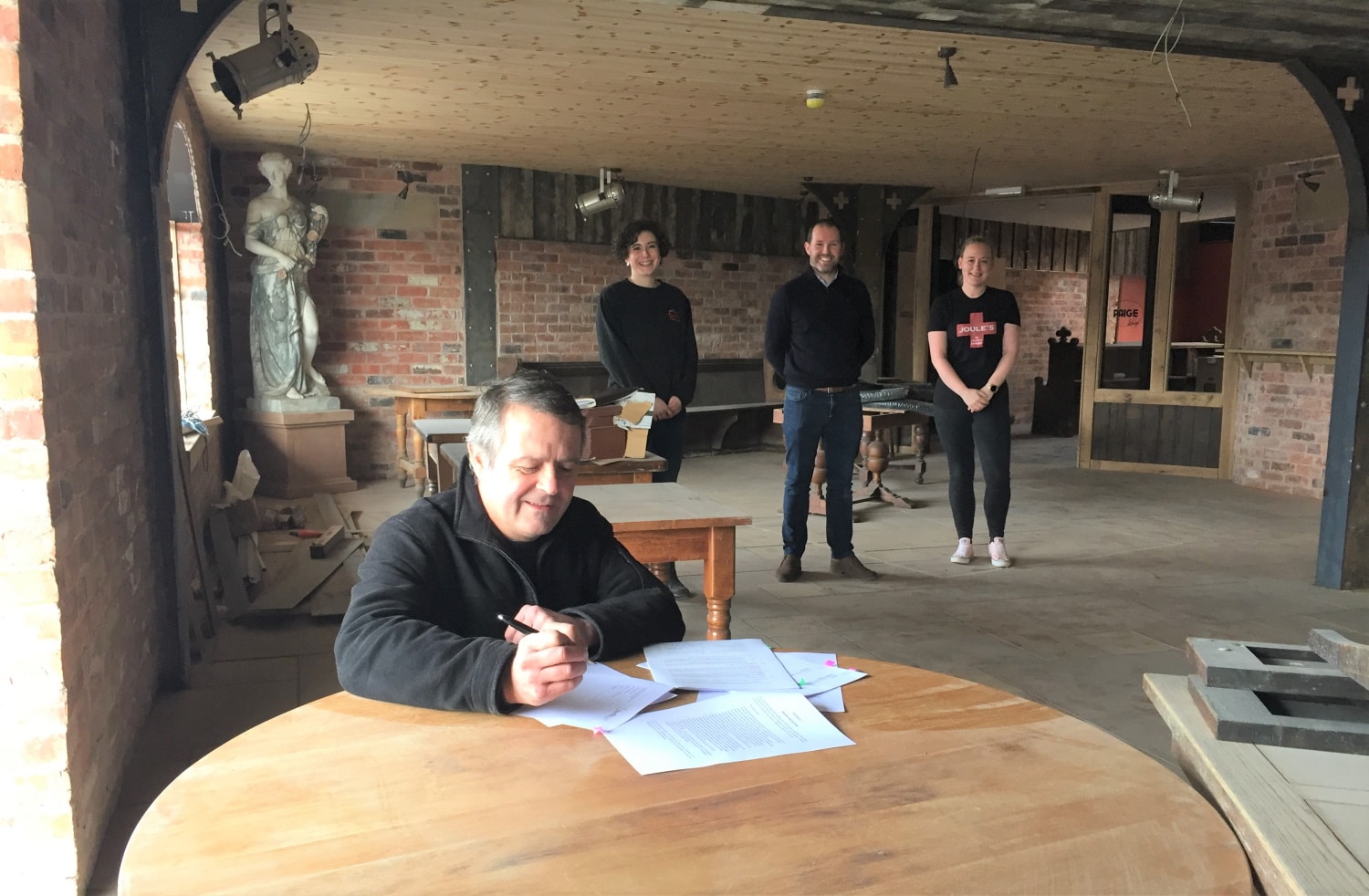 Crown Wharf Theatre trustee Rob Kenney signs the lease