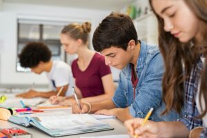 High school students doing exam in classroom