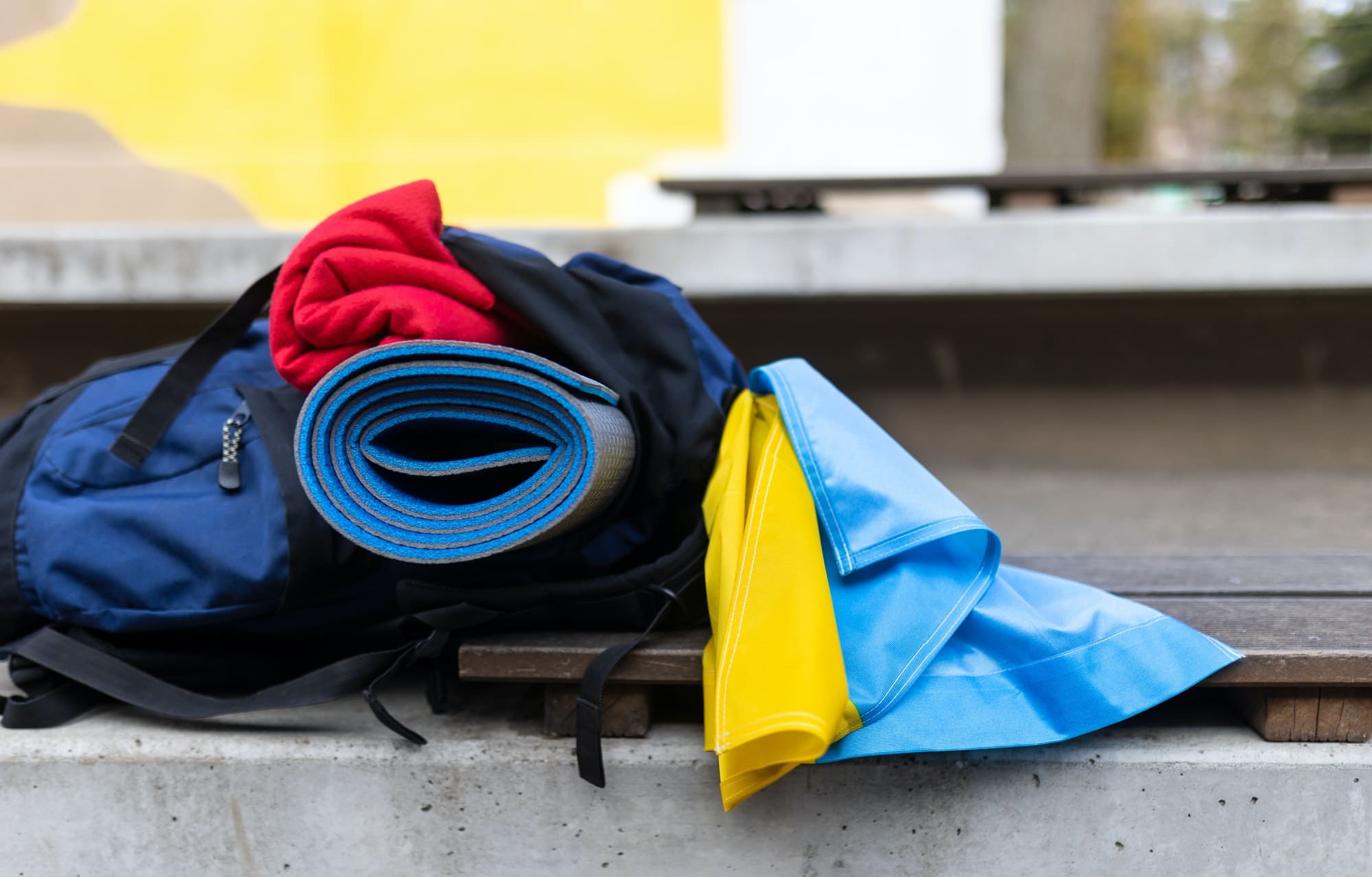 Packed luggage of Ukrainian refugee in station