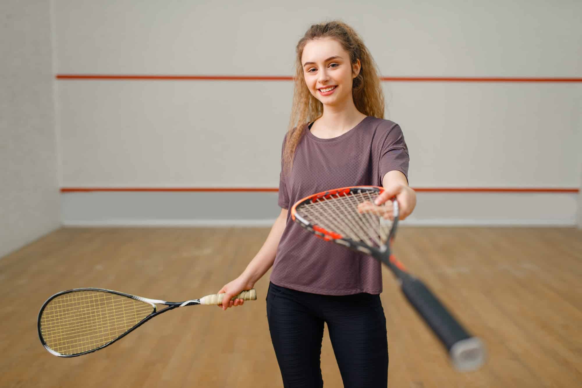 Female player gives squash racket
