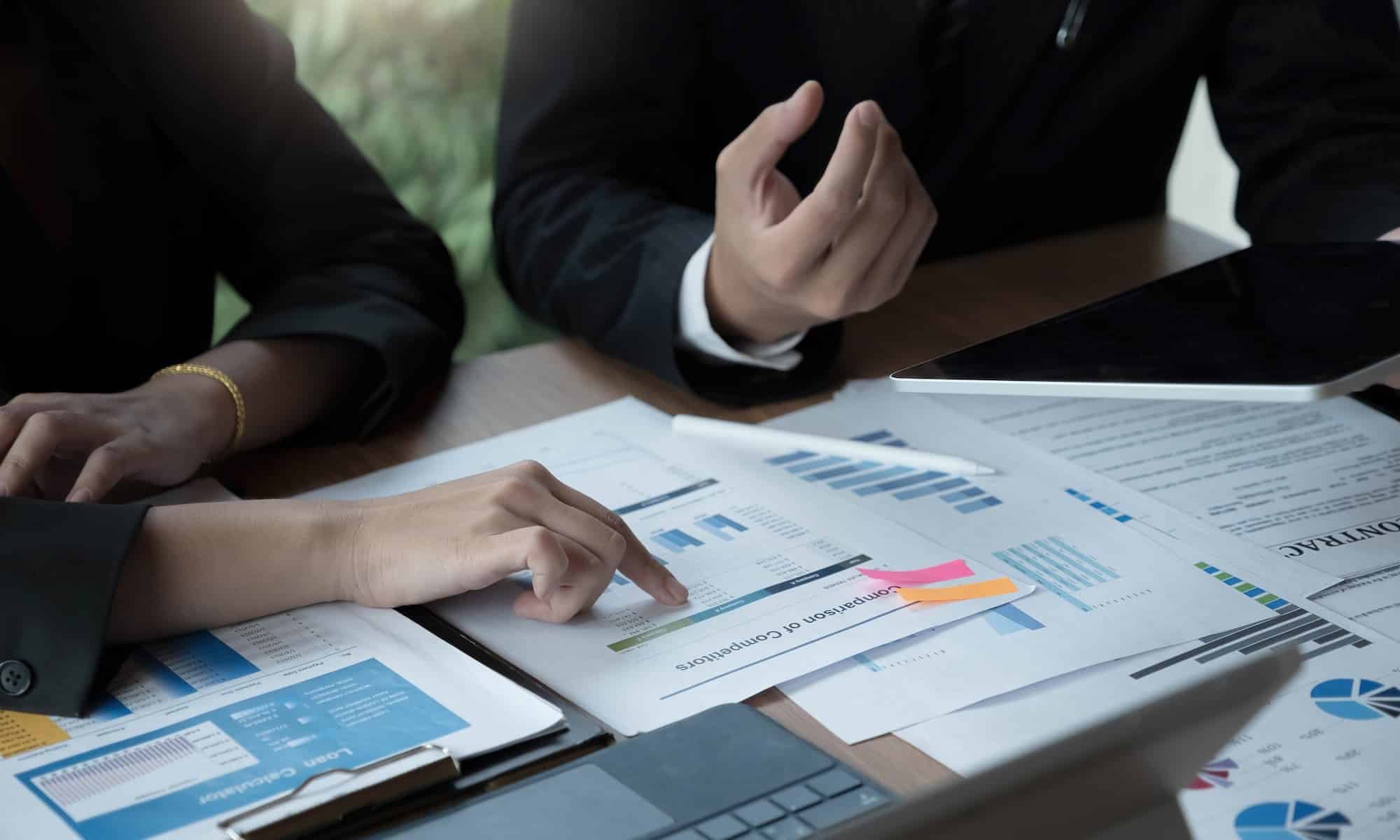 Fund managers team consultation and discuss about analysis Investment stock market by digital tablet