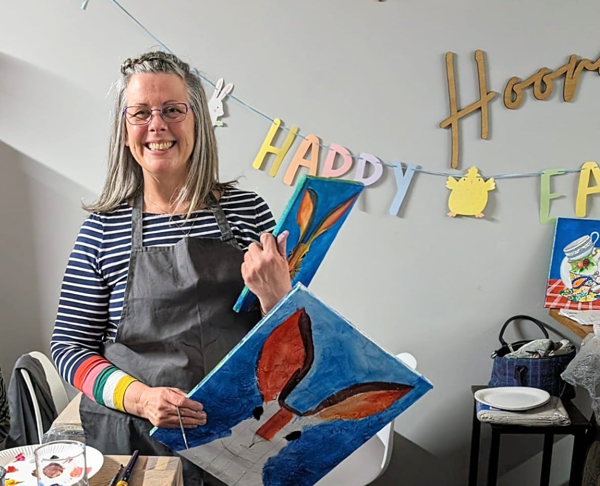 Tania Paling Sparkes holding paintings