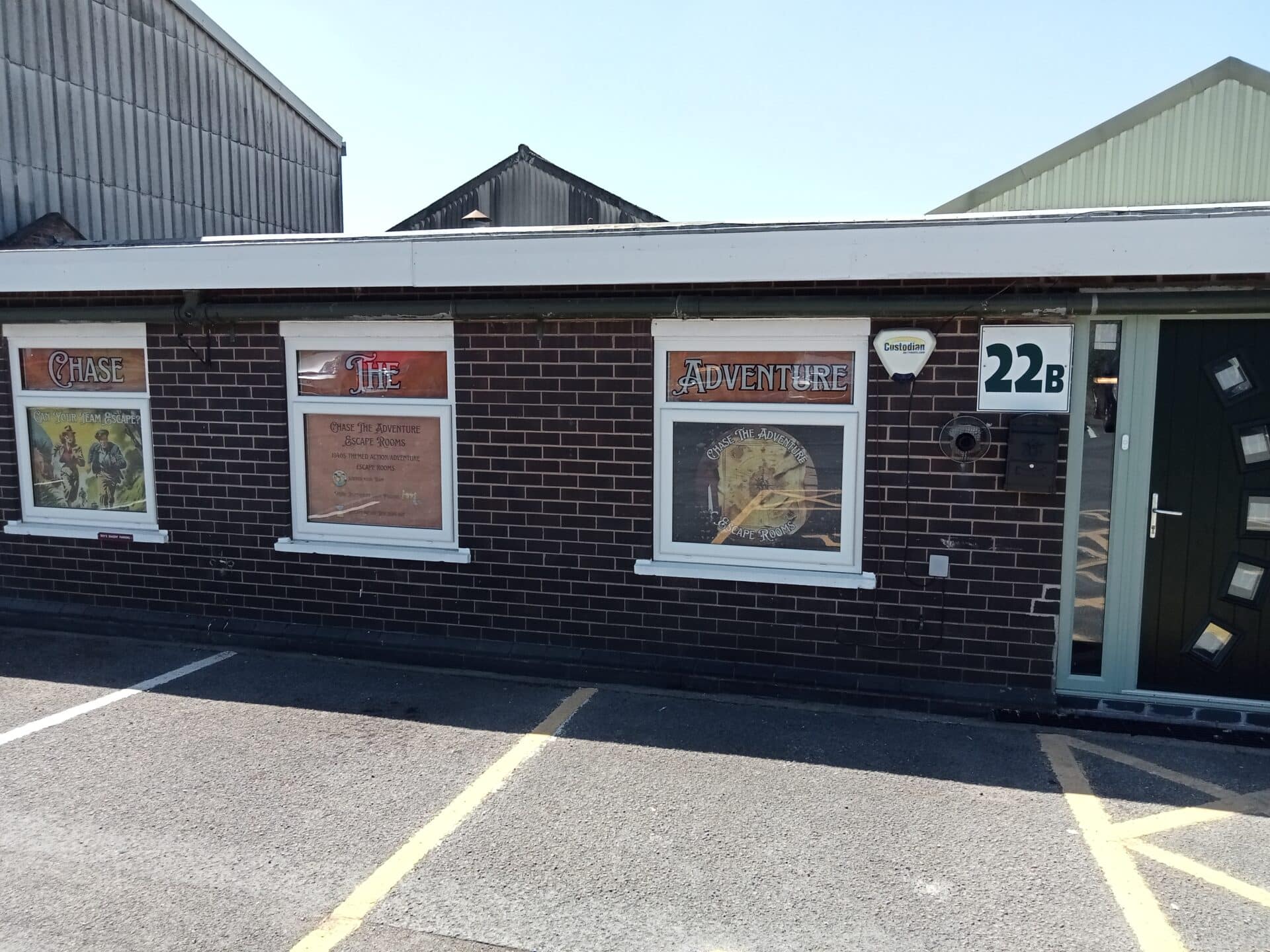 Front entrance of Chase The Adventure Escape Rooms at 22B Whitebridge Estate, Stone, with themed window graphics and clearly marked unit signage.