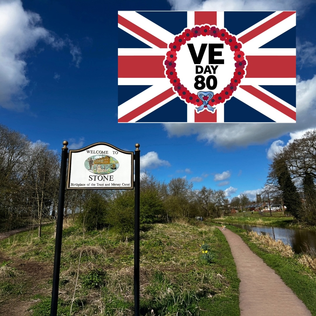 Stone welcome sign by the Trent and Mersey Canal on a bright spring morning, overlaid with a Union Jack poppy wreath graphic reading “VE Day 80”, marking Stone VE Day celebrations.
