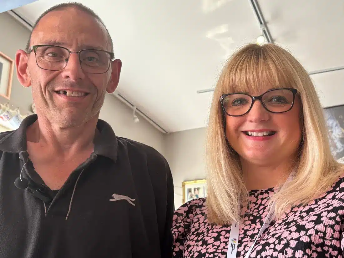 Paul Challinor, a carer from Hilderstone, stands smiling beside Jane Carpenter from Together for Carers inside a well-lit room