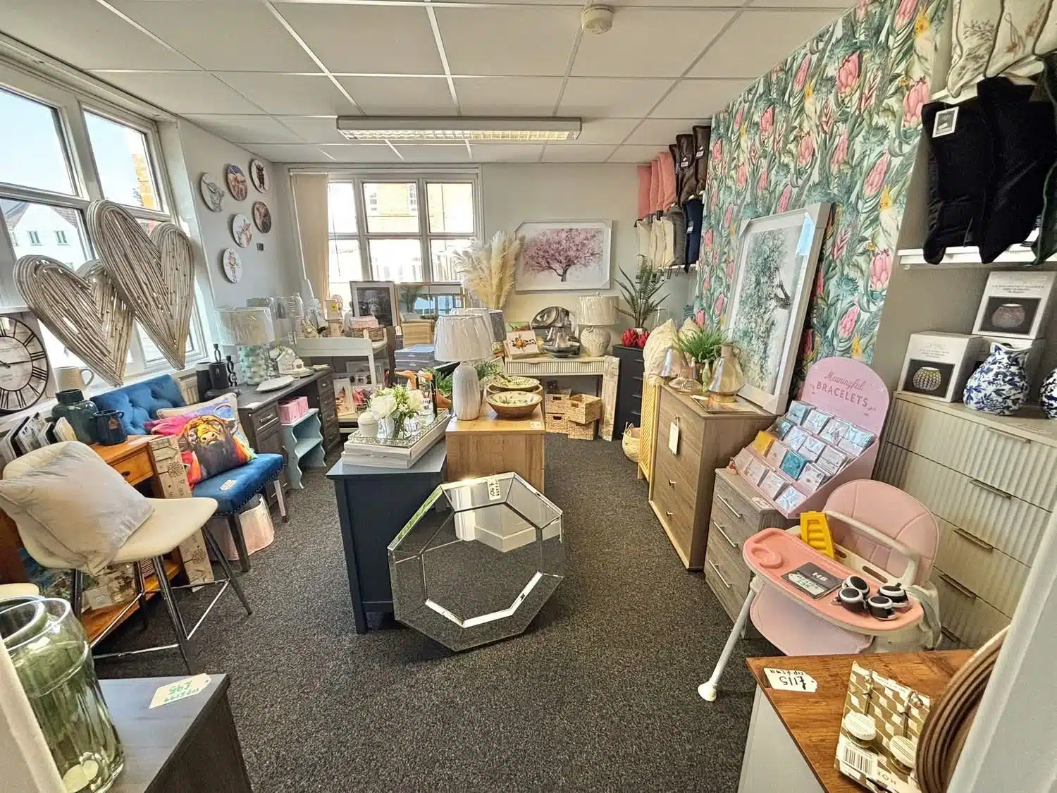 Wide-angle shot of the main showroom at LCT Homewares with heart decorations, home accessories and floral wallpaper feature wall.