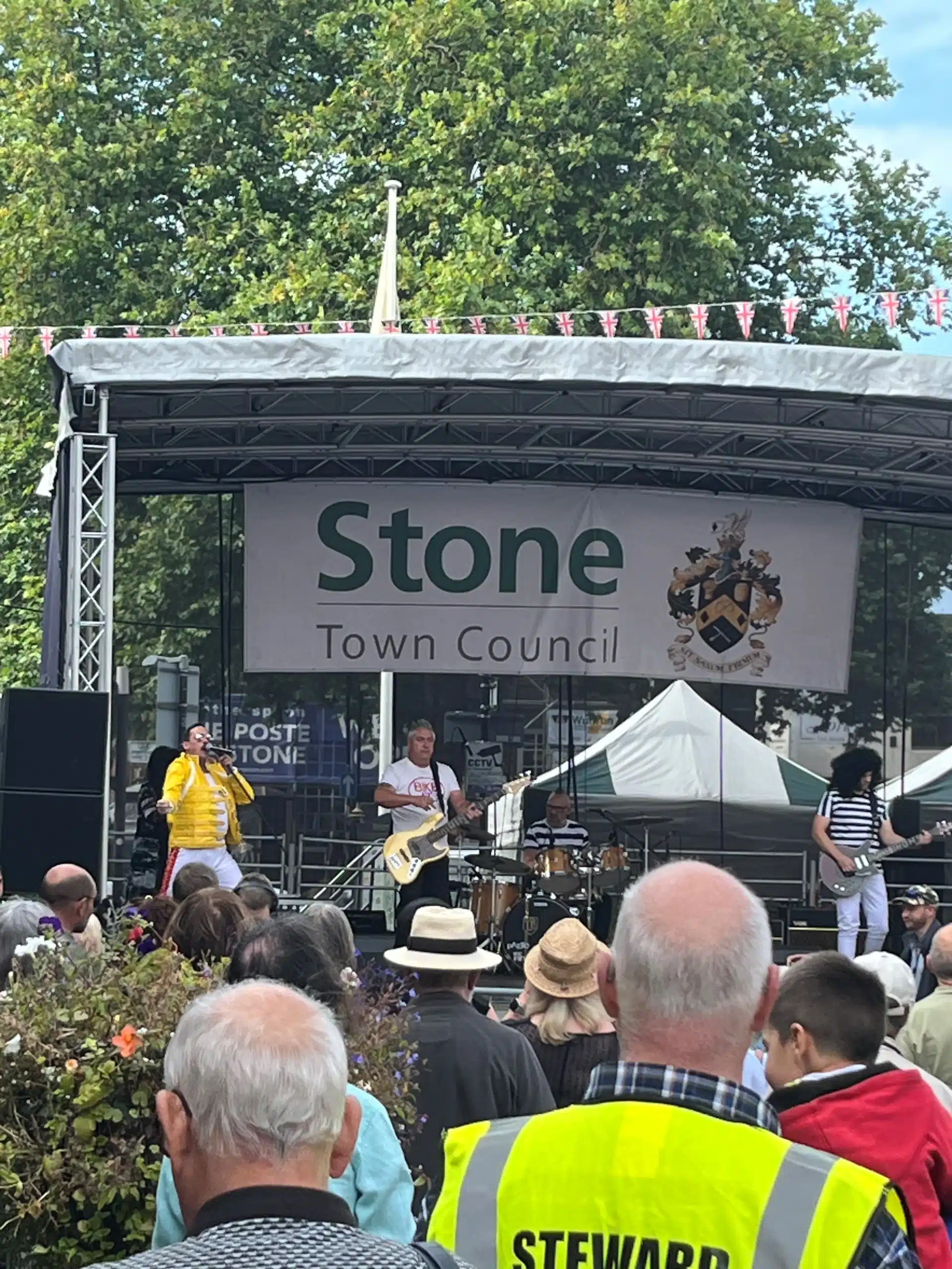 Families enjoying live music at a summer street party in Stone High Street