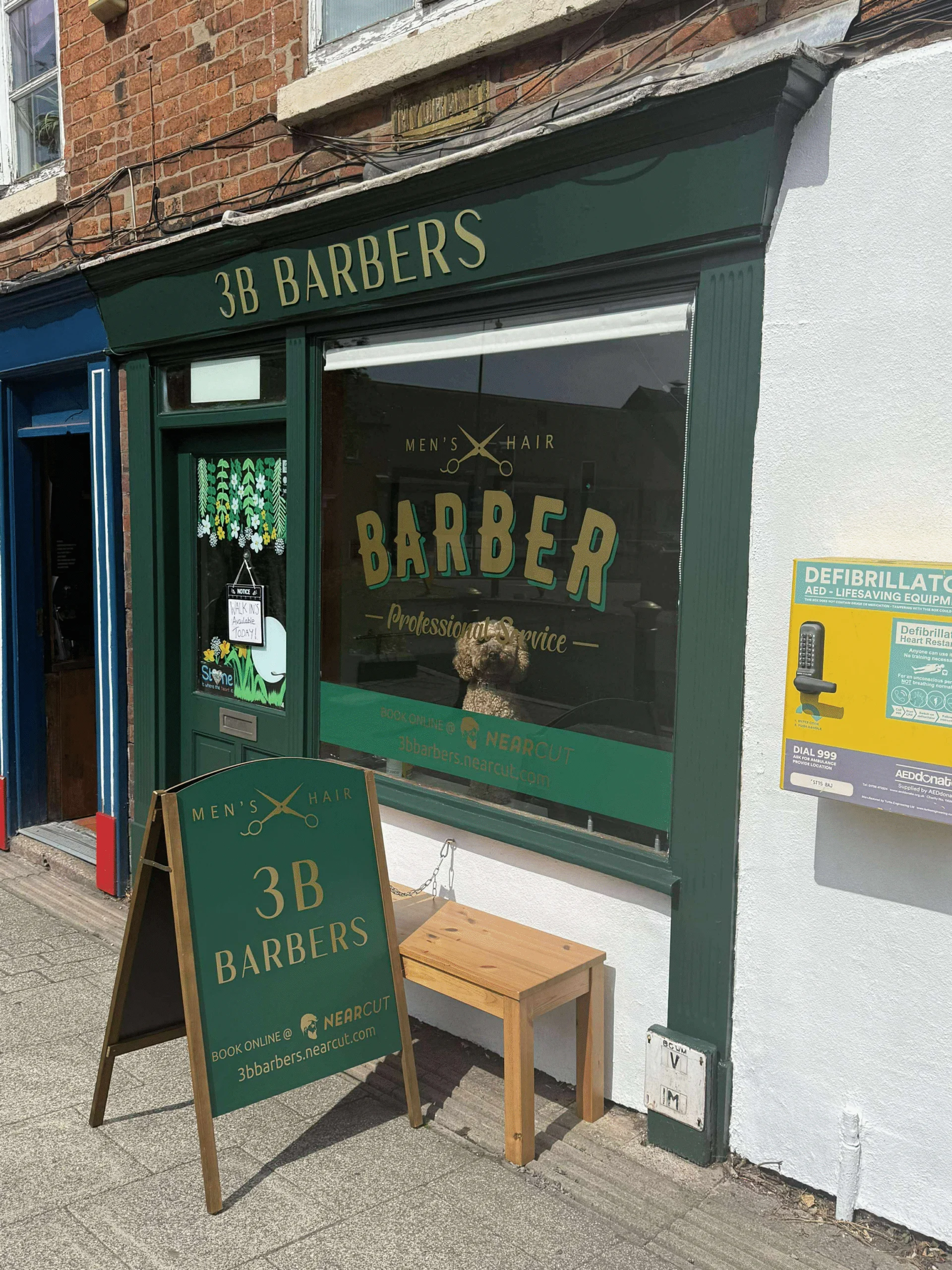 The newly decorated shopfront of 3B Barbers on Stone High Street, with new signage and a wooden bench outside.