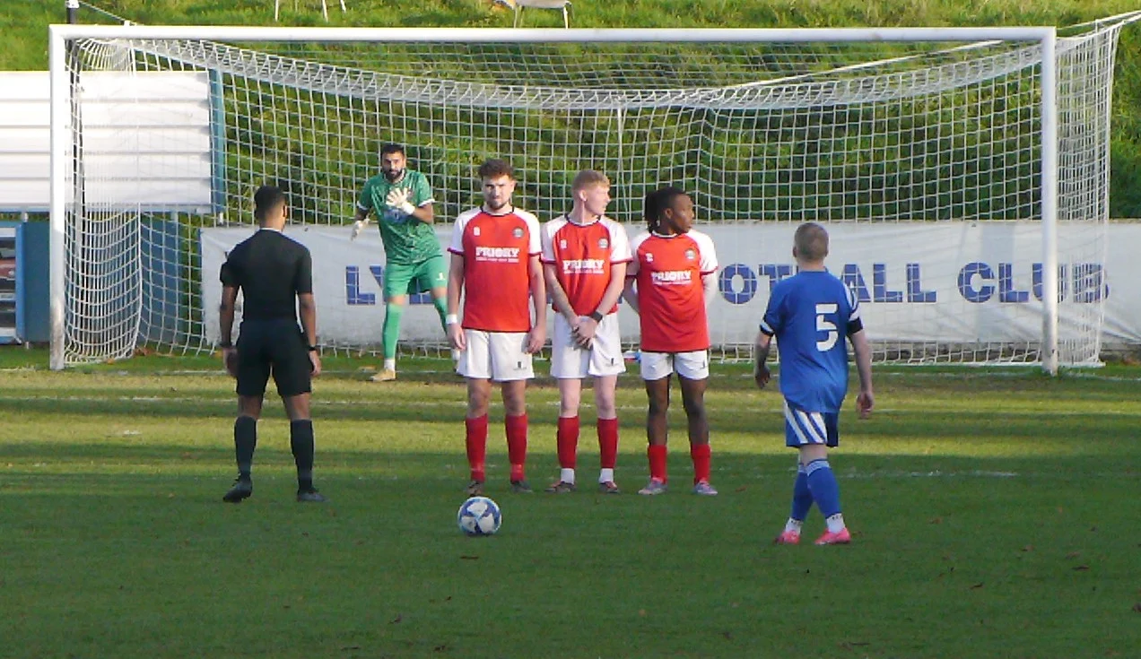 Stone Old Alleynians wall defends a Lye free kick.