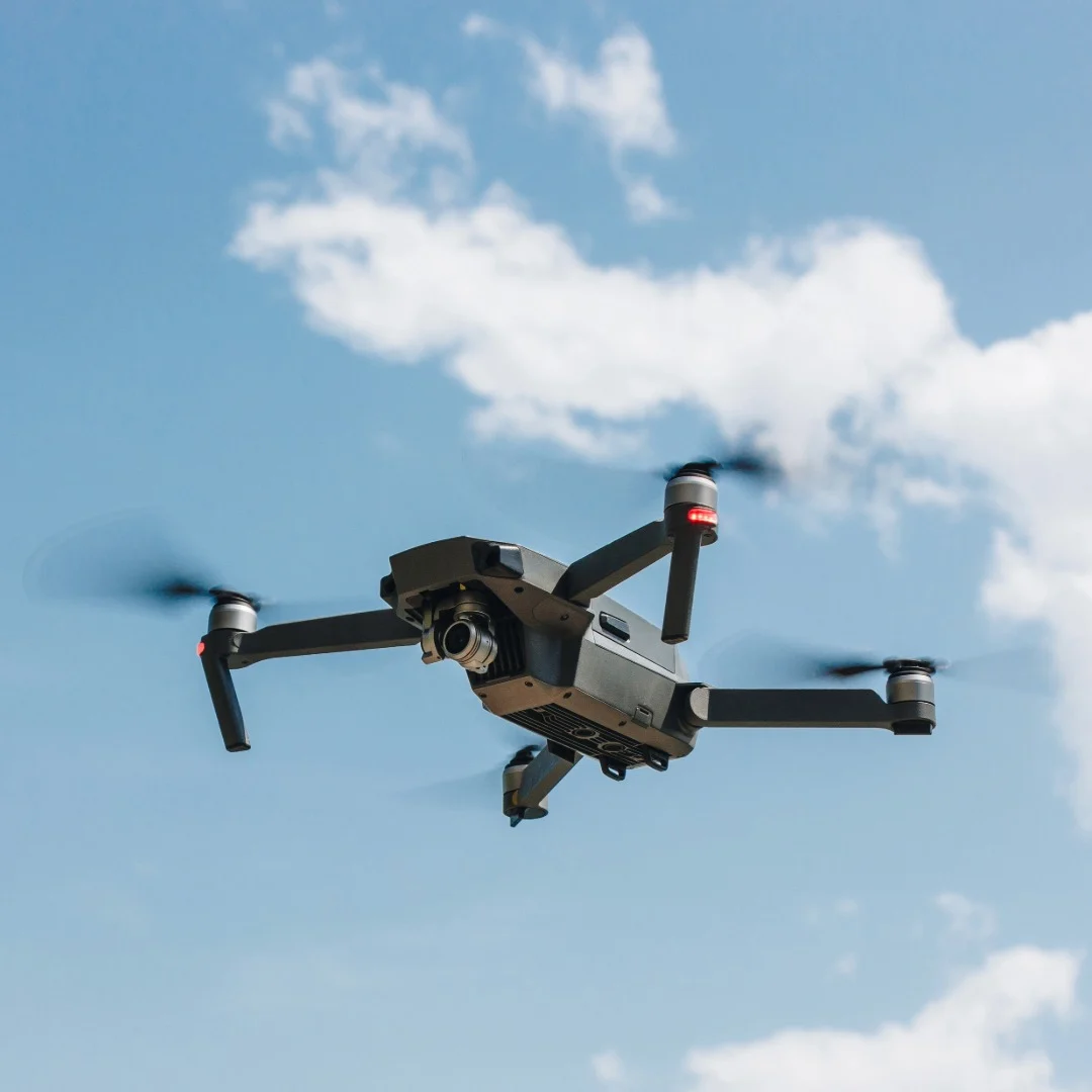 Drone in a blue cloudy sky