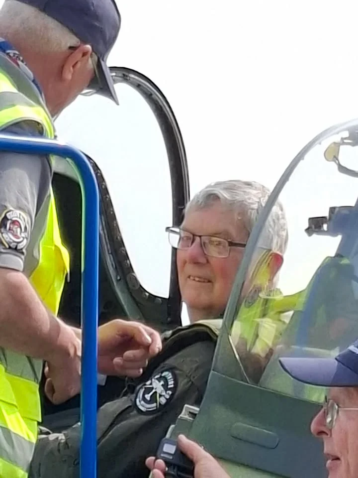 Mike being helped in the cockpit.
