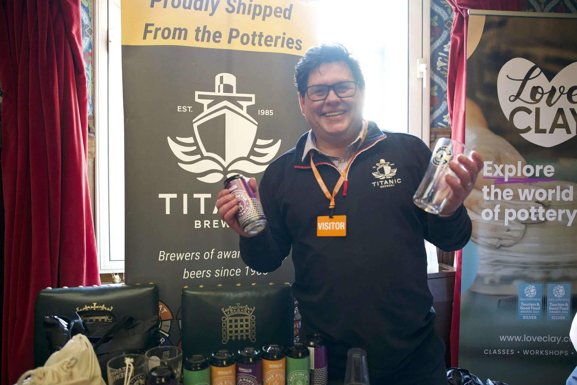 Representative from Titanic Brewery holding a can and glass at the Staffordshire showcase event at the House of Commons.
