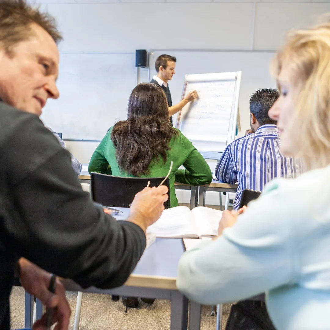 Adult learners studying together in a classroom as Staffordshire providers are approved for flexible higher level learning finance.