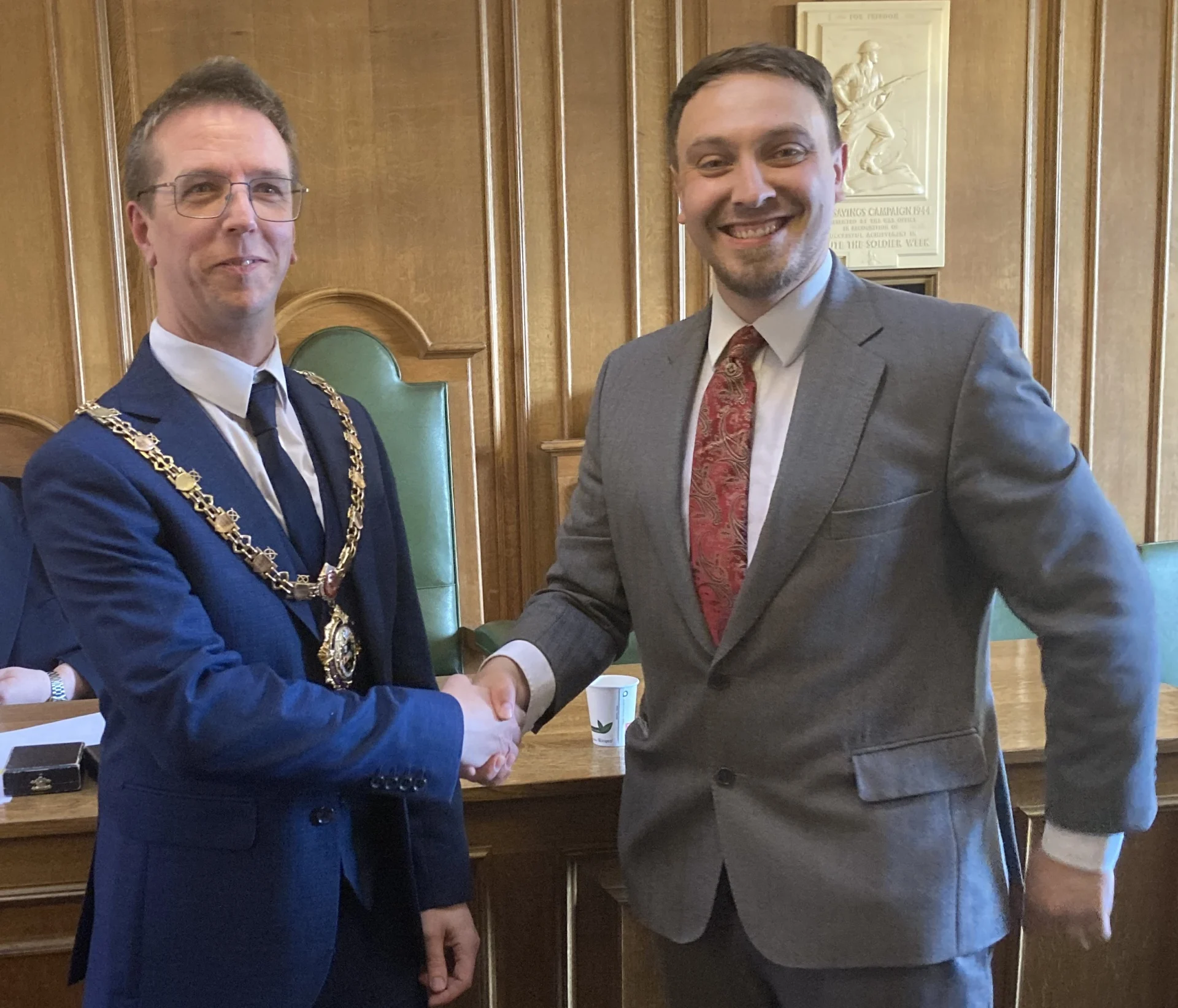 New Stone Town Mayor Andrew Best shakes hands with outgoing Mayor Jason Metters at Stone Town Council.