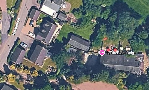 Aerial view of Squirrel Barn Lodge off Sandon Lane in Milwich, with neighbouring buildings and fields visible.