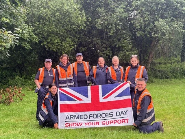 Landmarc staff at Swynnerton Training Camp holding an Armed Forces Day flag during Armed Forces Week 2026.