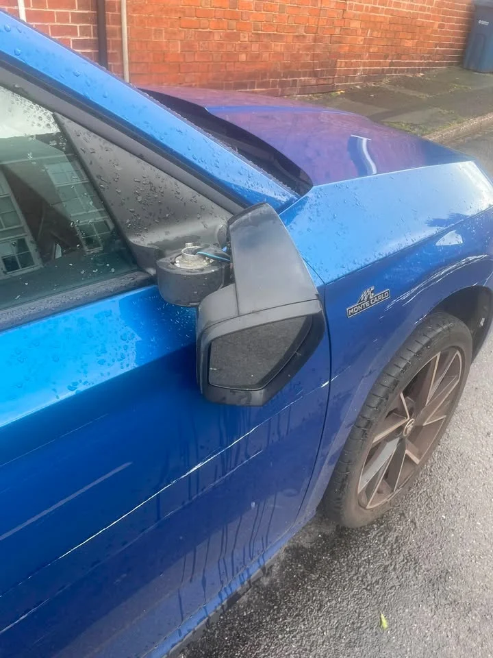 Blue car with damage to the wing mirror and side panel after being parked on Berkeley Street in Stone.