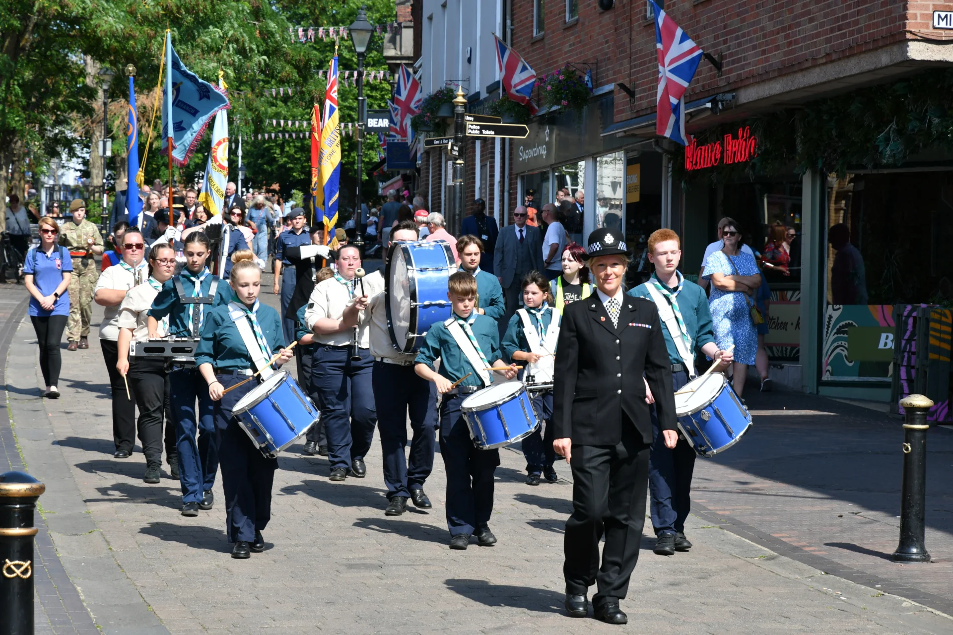 A previous Civic Sunday parade makes its way along Stone High Street, led by drummers and standard bearers.