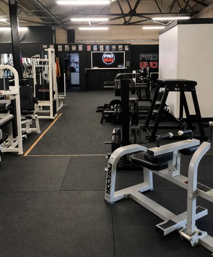 Interior of Pro Evolution Fitness on Mount Industrial Estate in Stone, showing gym equipment and Pro Evo signage.