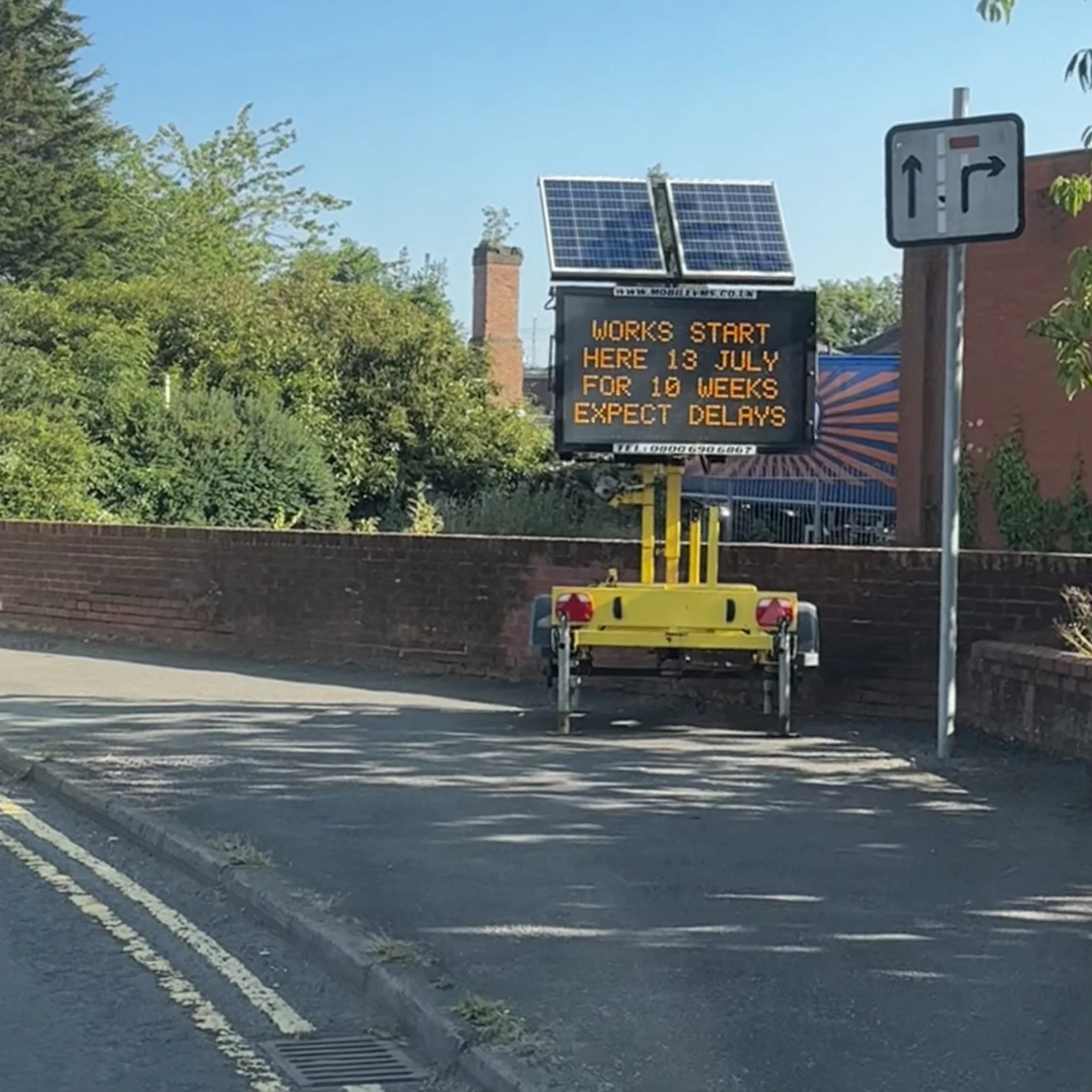 Illuminated roadworks sign on Crown Street in Stone warning that works start on 13 July and drivers should expect delays.