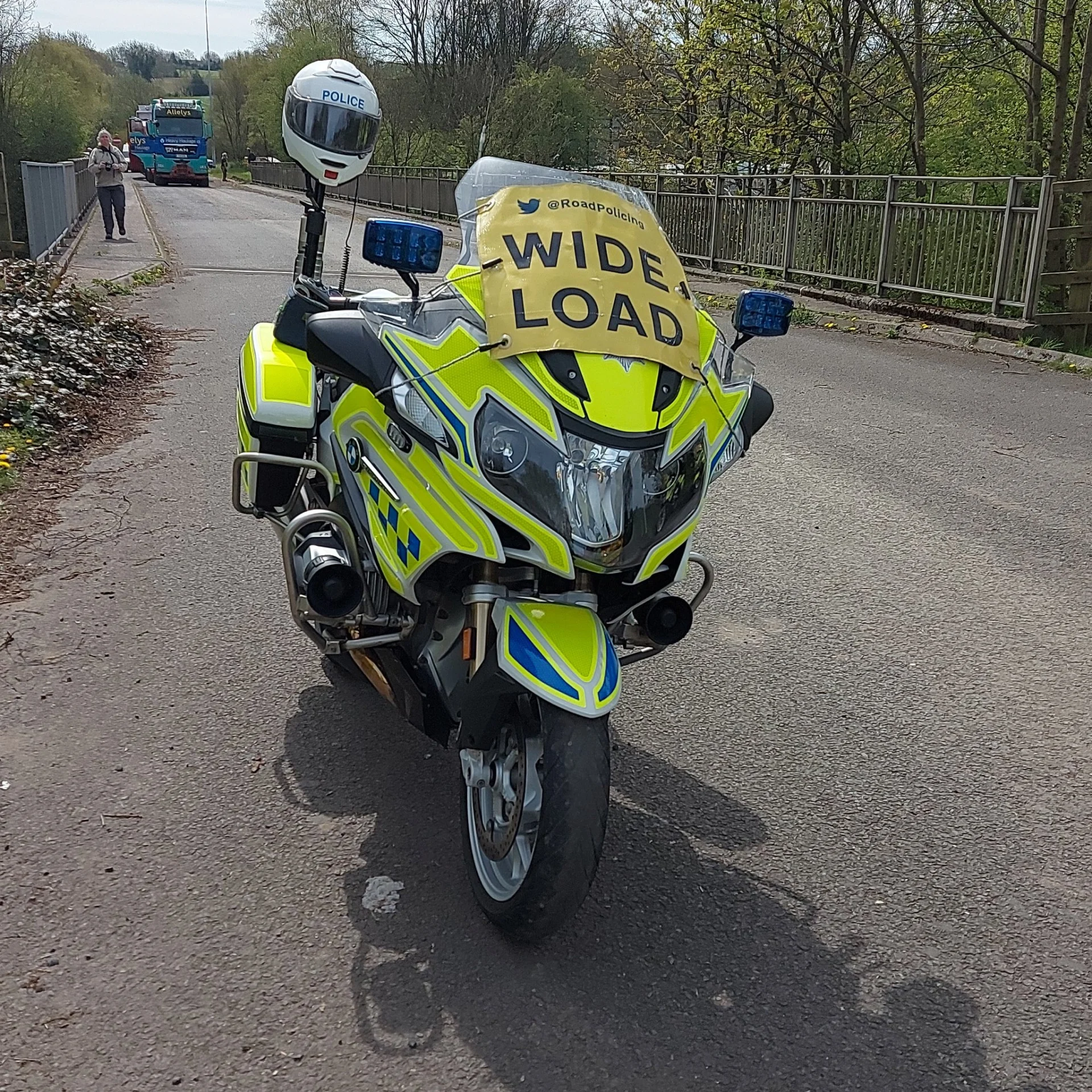 Police motorcycle displaying a Wide Load sign during an abnormal load movement in Staffordshire.