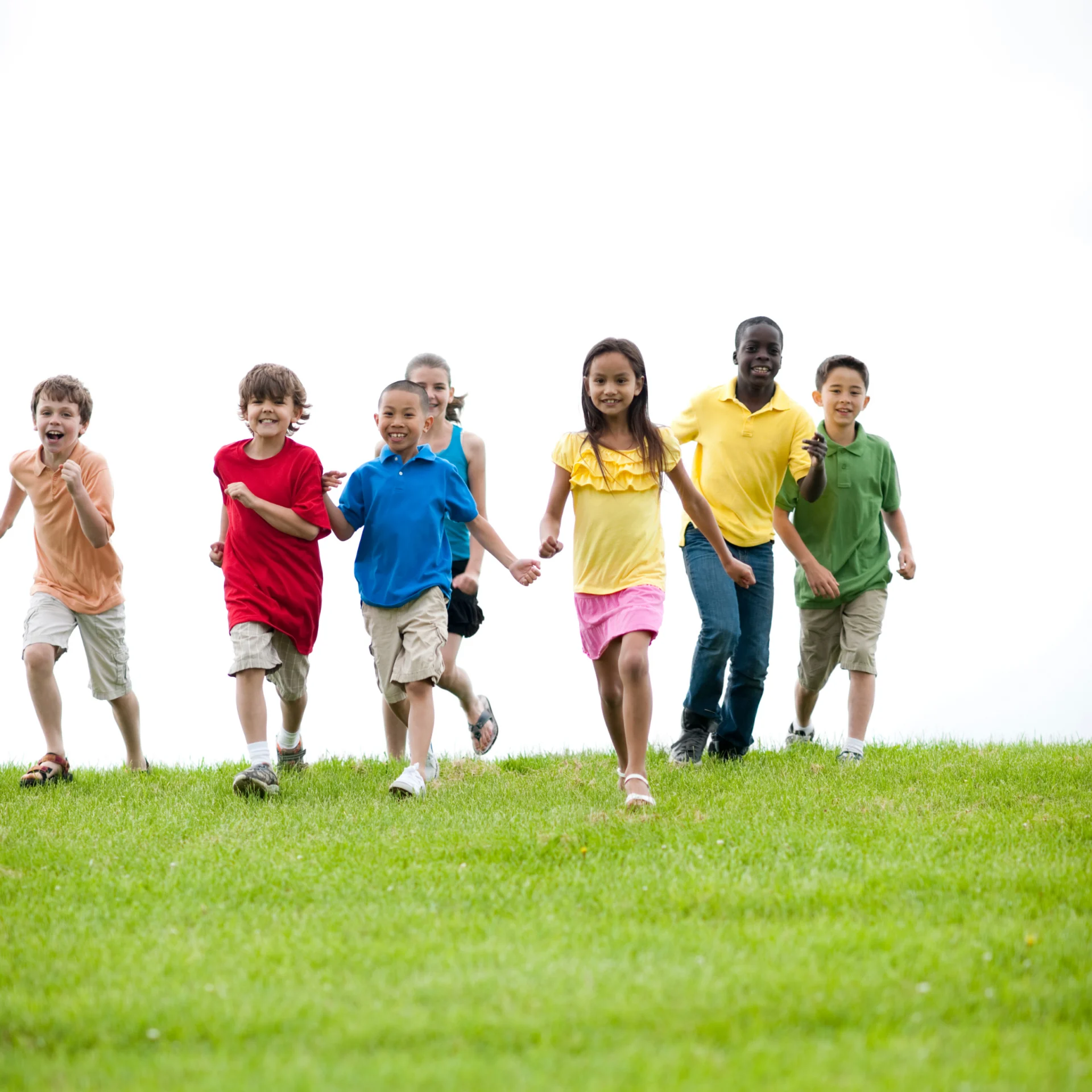 Kids running over the green grass