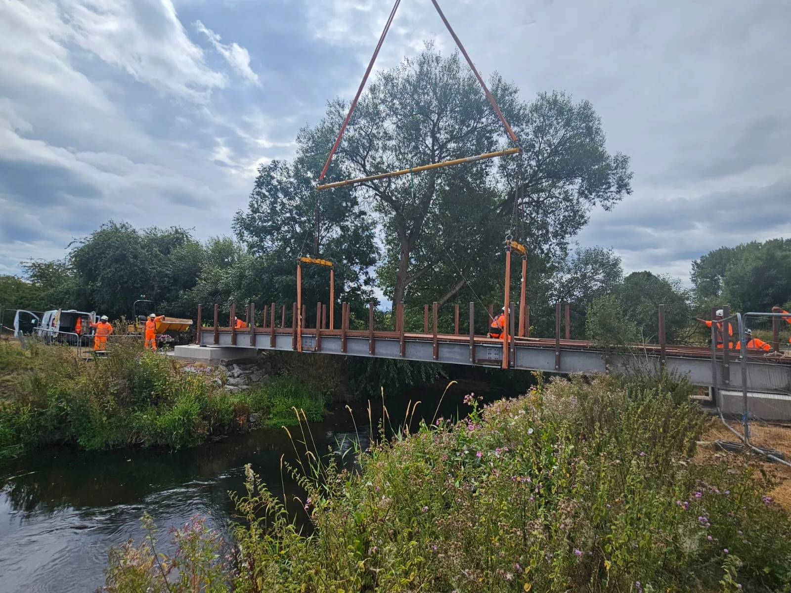 Workers preparing to lift and position the new footbridge on Sandon and Burston Public Footpath 36 near Stone.