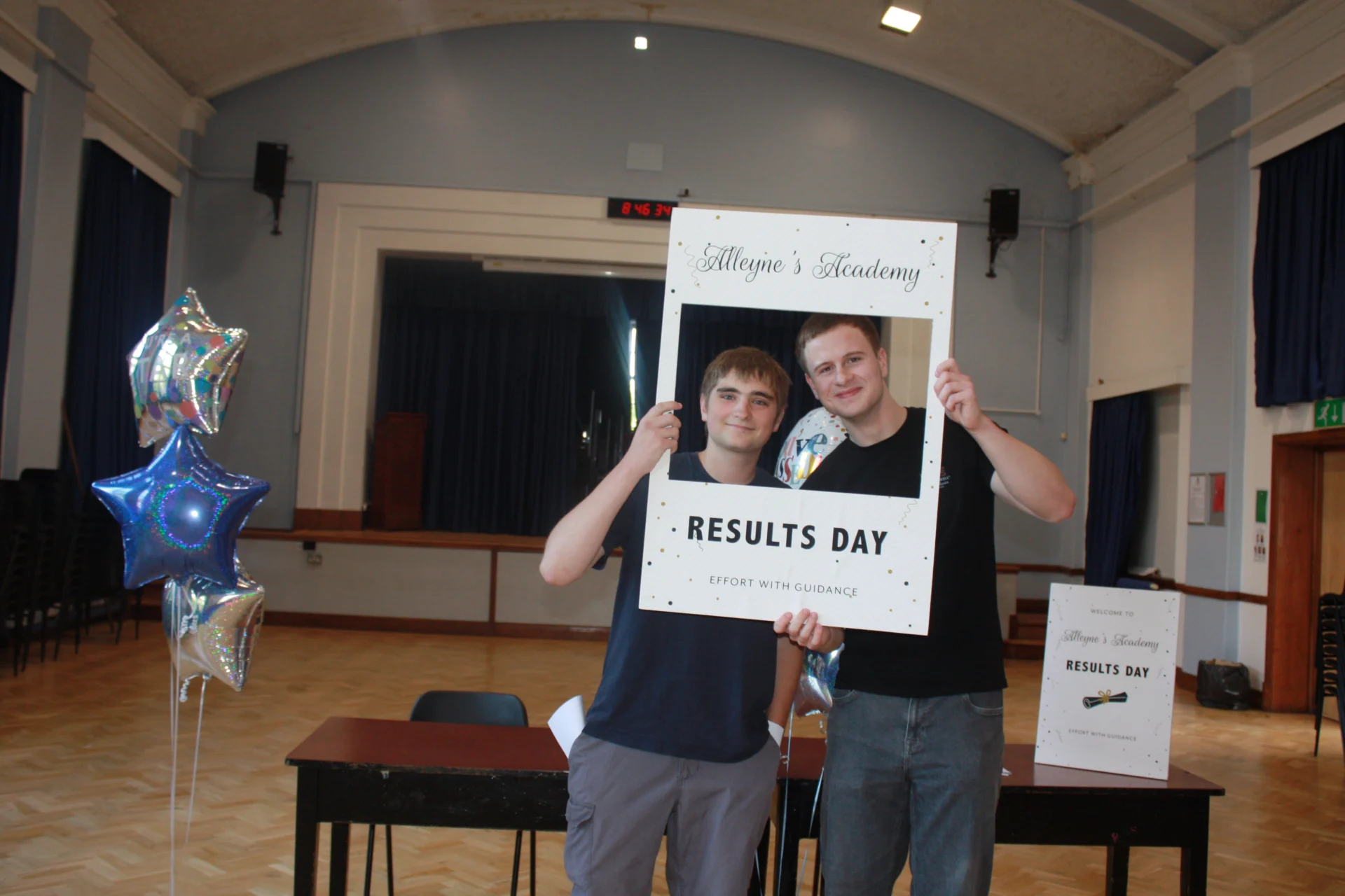 An Alleyne’s Academy student holding a Results Day photo frame in the school hall in Stone.