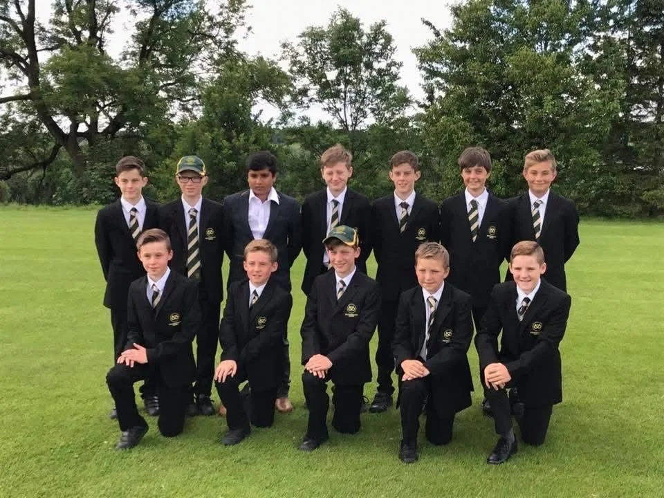 A group of young cricket players in club blazers posing on a cricket field in a photograph shared by Stone SP Cricket Club.