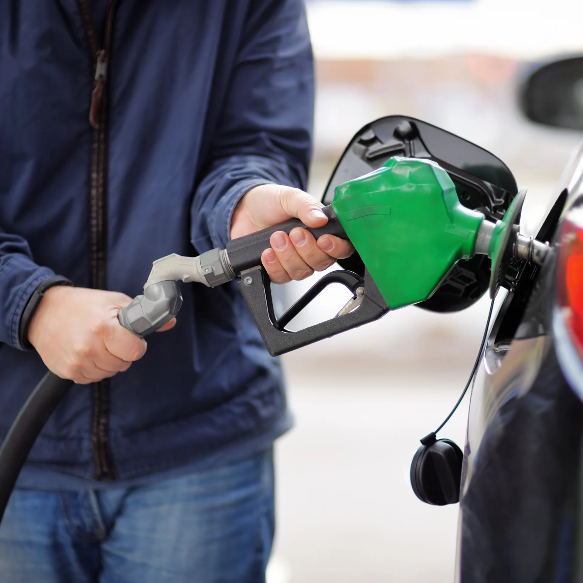 Man filling his car with unleaded petrol in Stone