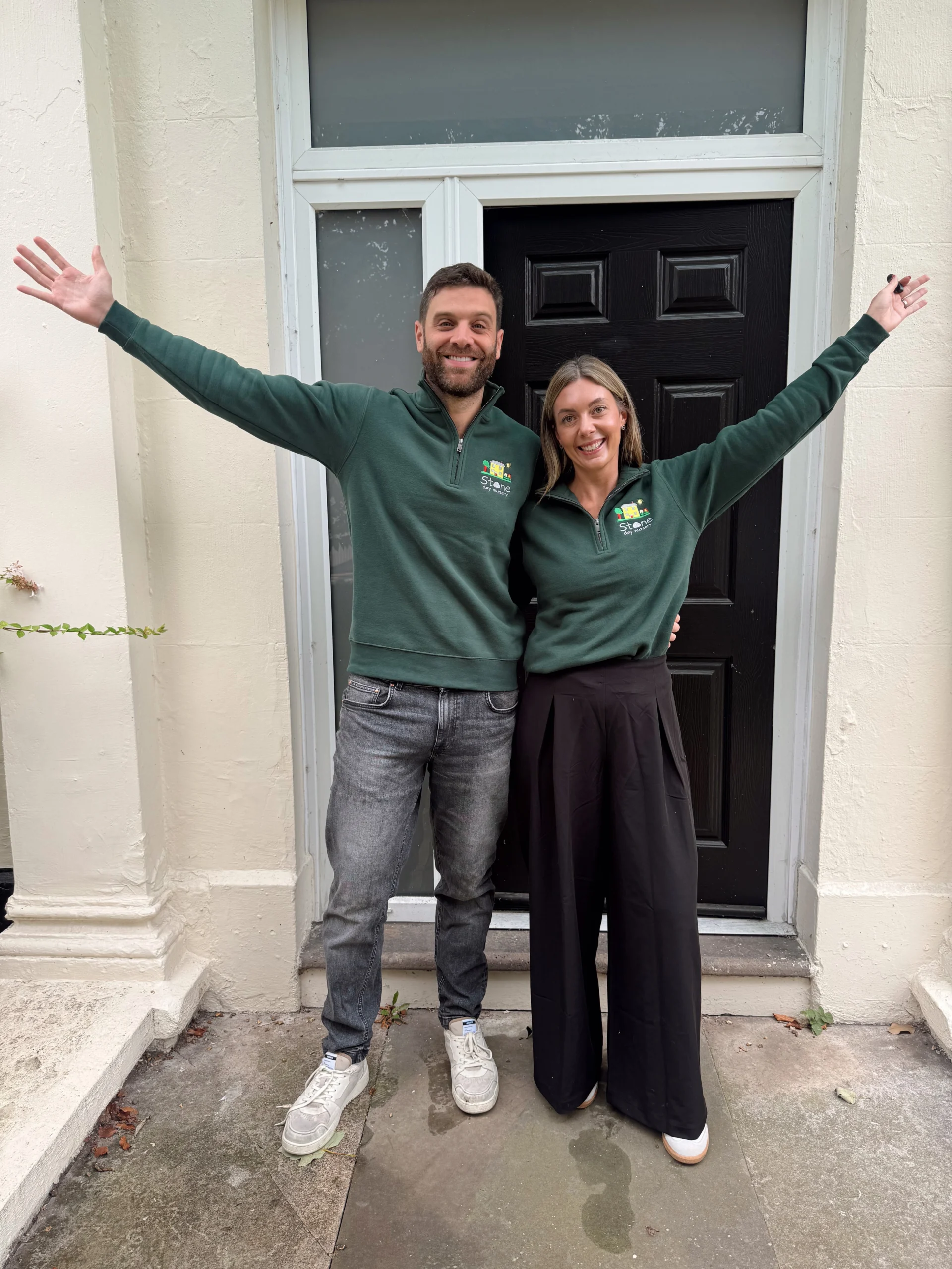 Claire and Ed on the front steps of the new Stone Day Nursery