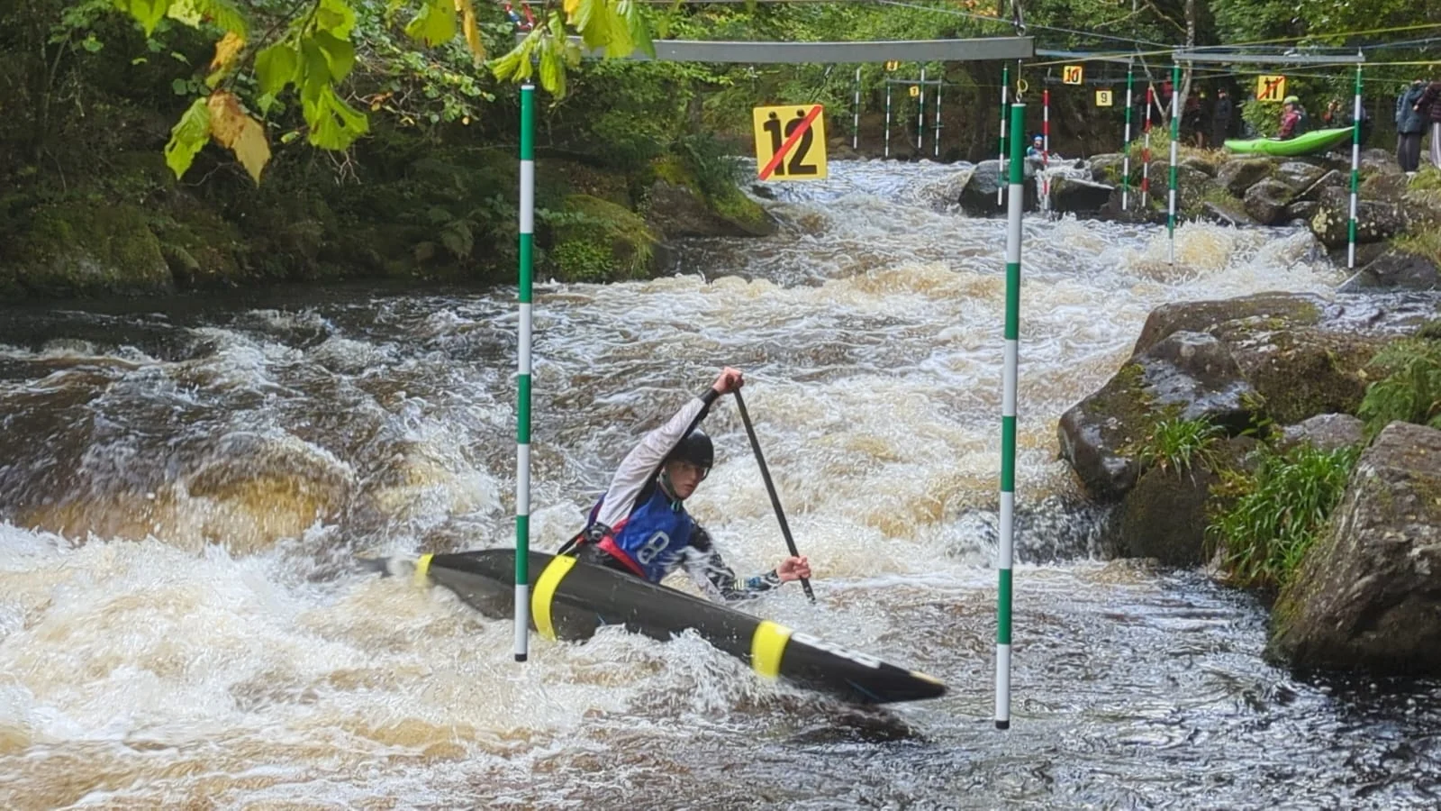 Nathan competing in a canoe slalom event.