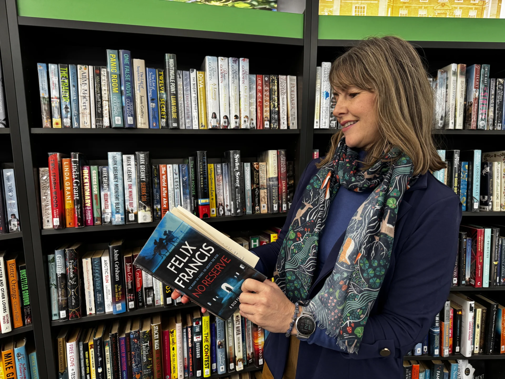 Councillor Hayley Coles, Staffordshire County Council’s cabinet member for communities and culture, looking at a book inside a library.