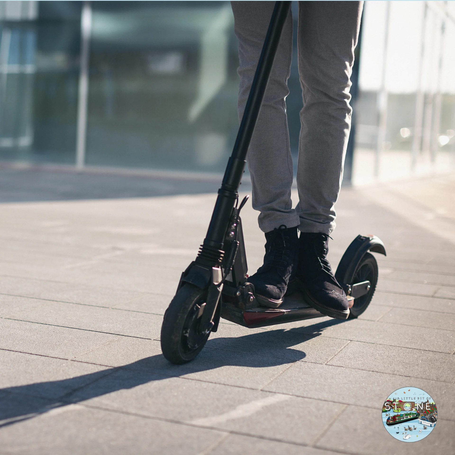 escooter being ridden on a pavement